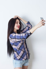 Beautiful woman taking selfie with her smartphone