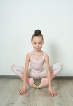 A little adorable young ballerina posing and stretching