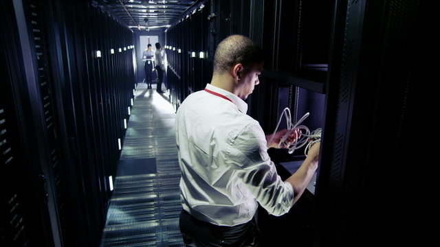 Time lapse of a team of IT engineers working in a data centre