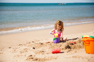 Little girl playing at the beach