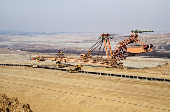 Giant mining excavator on the bottom surface mine.