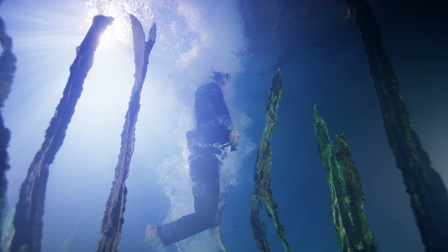 Drowning businessman underwater breaks free from his chains