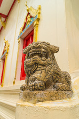 the ancient chinese lion stone carving under sunlight