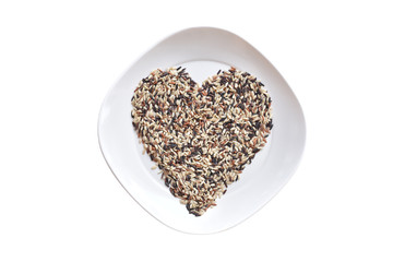 Heart shape of rice in white dish on white background.