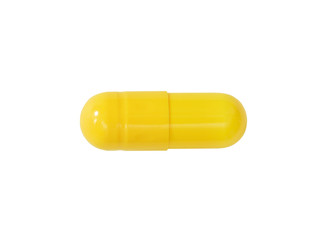 Macro yellow medical pill tablet isolated on white