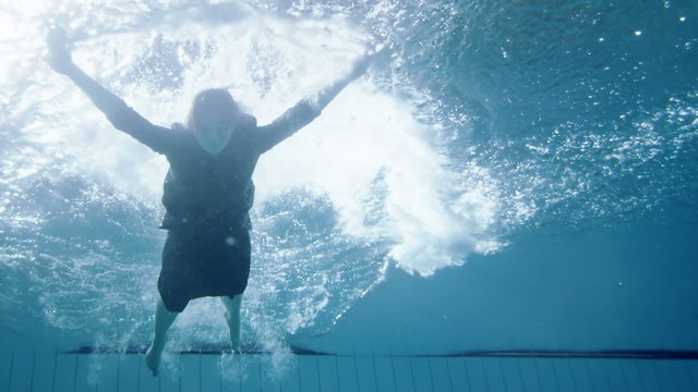 Drowning underwater businesswoman struggling to make it out of deep water