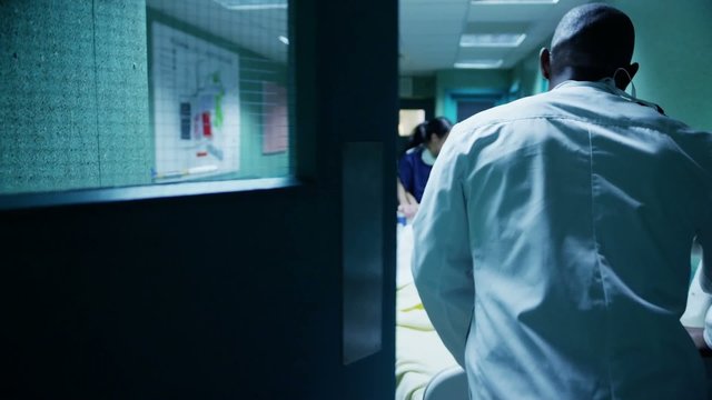 Hospital emergency team rush a patient on a gurney to the operating theatre.