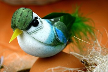 Easter bird made of polystyrene and plastic sitting on egg shell