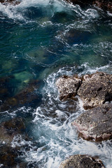 Ocean water splashing against rocks in the Galapagos Islands