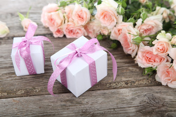 Bouquet of pink roses and gift