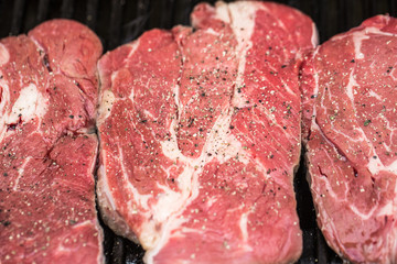 Fresh beef steaks on grill or BBQ
