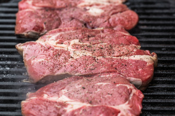 Fresh beef steaks on grill or BBQ
