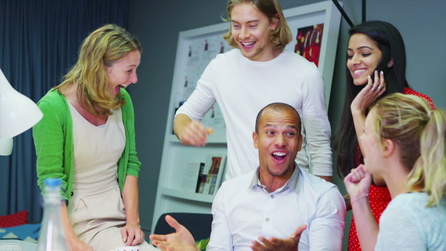 Cheerful creative business team high five each other