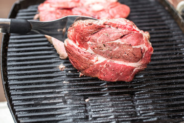 Beef steaks on grill or BBQ with spatula
