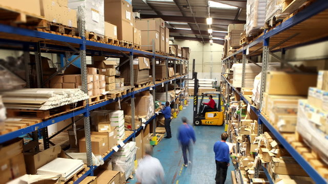 Time lapse of male workers in warehouse preparing goods for dispatch