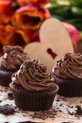 Mothers day  chocolate cupcakes  with spring tulips and wooden h