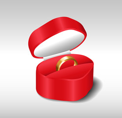 Gold wedding ring in a red stylish heart-shaped box