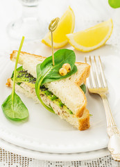 Appetizing sandwich with chicken, spinach, avocado and poppy