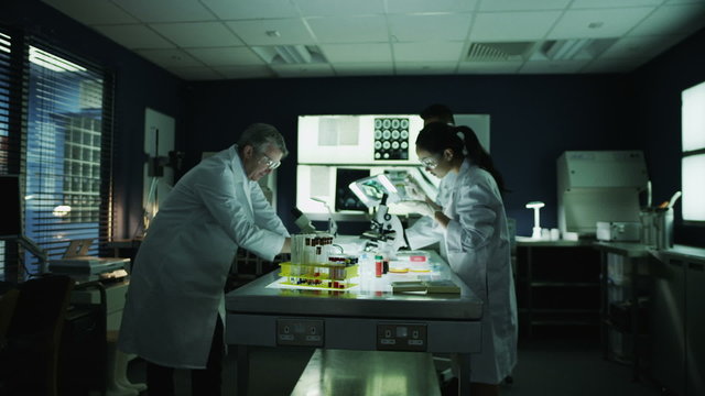Zoom out from medical research team working together in a laboratory