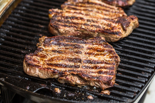 Beef steaks on grill or BBQ with spatula