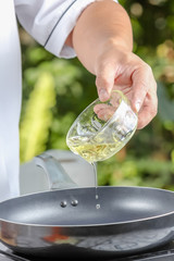 chef pouring  oil