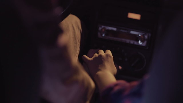 Couple in a car holding hands