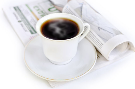 A cup of hot coffee and newspaper