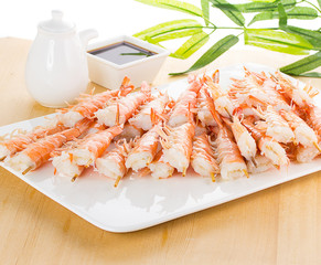 iger shrimps on white plate over wooden background