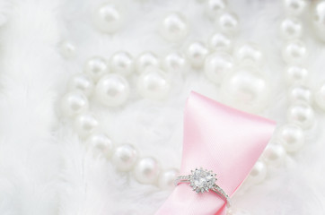 heart engagement diamond ring with pink ribbon and pearl