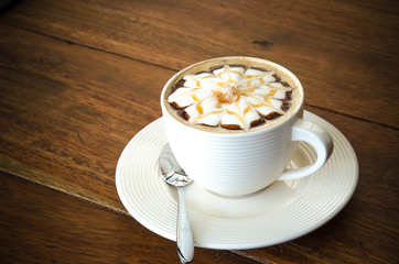 A cup of coffee with flower pattern