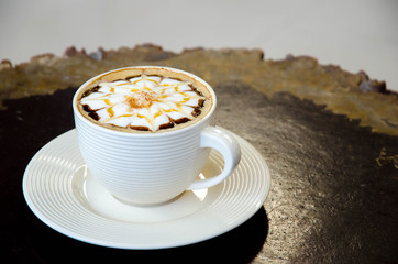 A cup of coffee with flower pattern
