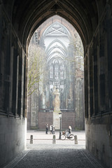 tourists in centre of utrecht seen from under the dom tower