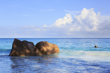 Beautiful granite boulders in Indian Ocean on the beach of Anse