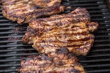 Beef steaks on grill or BBQ