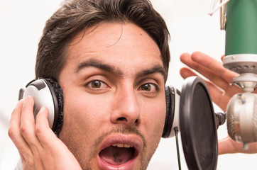 handsome man singing in music studio