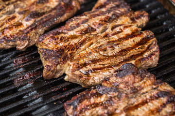 Beef steaks on grill or BBQ
