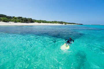 Remote tropical paradise white sand beach full of healthy coral in clear blue turquoise lagoon, Okinawa
