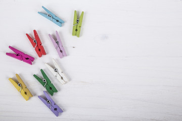 colorful cloth pegs on wooden surface