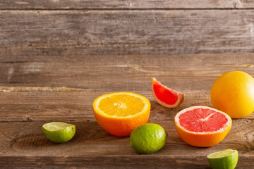 sliced citrus fruits over wooden background