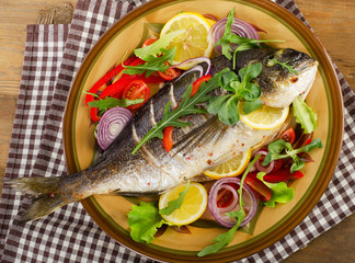 Fried dorado fish on plate with fresh  lemon.