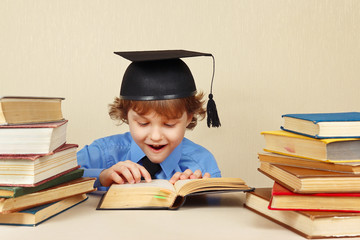 Little professor in academic hat reading an old books