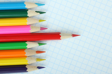 Obraz premium colored pencils on a notebook into a cell