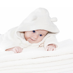 Blue eyes baby boy on white towels