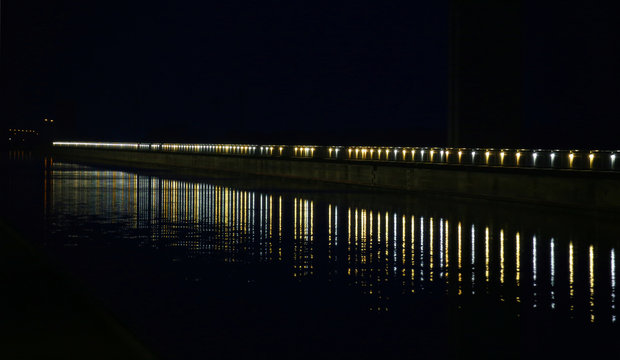 Long row of lights reflected on a river