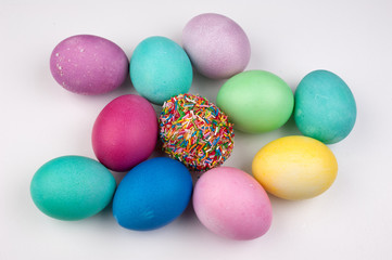 Fototapeta na wymiar colored easter eggs and one covered with sprinkles isolated