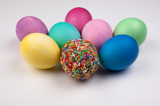 colored easter eggs and one covered with sprinkles isolated