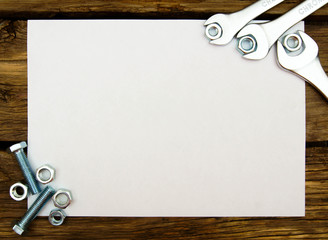 The Sheet of paper and fixing elements, wrenches on wooden