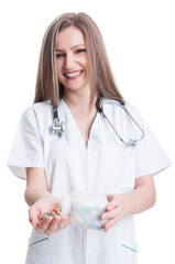 Woman doctor holding pills and transparent recipient