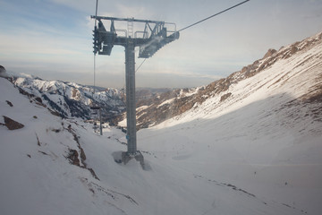 Fototapeta na wymiar The cable car in the snowy mountains Chimbulak