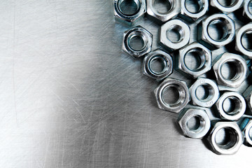 Nuts on scratched metal background.